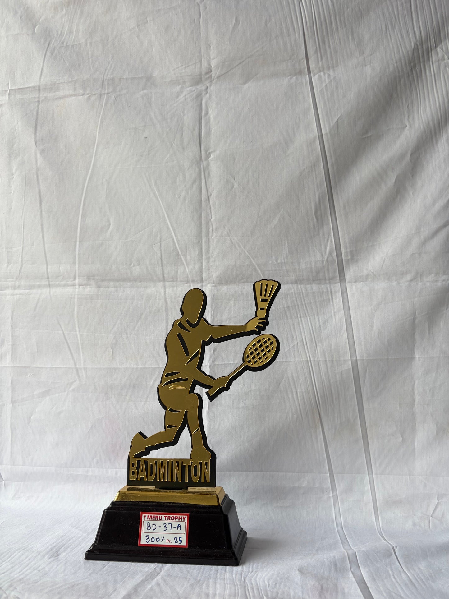 Gold badminton player silhouette on black base BD 37 A sports trophies for tournament winners by Meru Trophy.